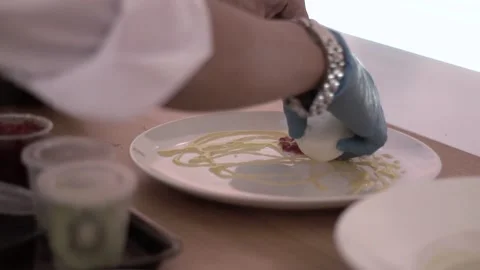 Established Shot of a Man Preparing Panna Cota on White Plate Stock Footage 132018460