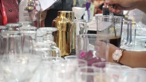 Established Shot of a Man Stir up Beverages With Ice Stock Footage 132020477