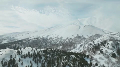 Establishing aerial view of Mount Etna covered in snow, winter landscape, sunny Stock Footage 342580896