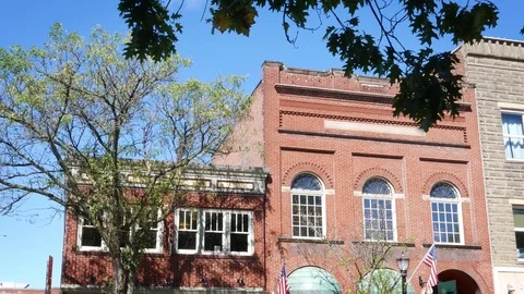 Establishing daytime shot of a group of second story offices above stores in sma Stock Footage