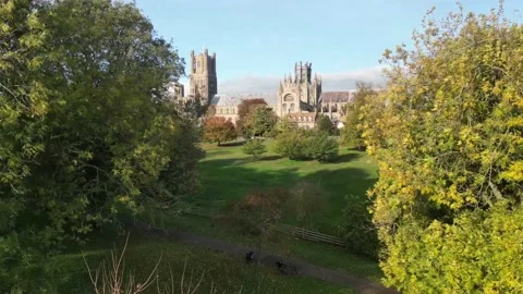 Establishing drone shot flying toward and over Ely Cathedral Stock Footage 226582030