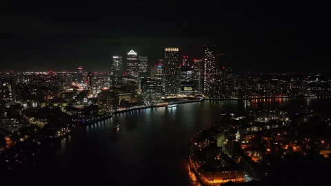 Establishing drone shot of Thames river and the Canary Wharf skyline, night in Stock Footage 314326807