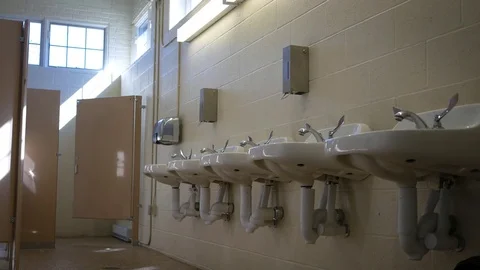 Establishing interior shot of empty public bathroom in the afternoon Stock Footage 80634696