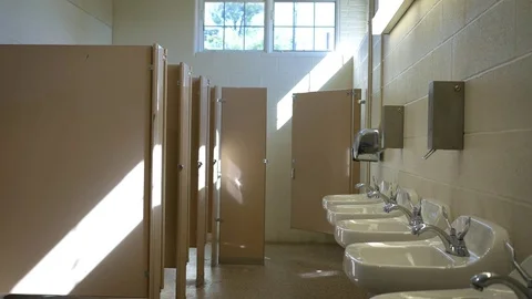 Establishing interior shot of empty public bathroom in the afternoon - ALT Stock Footage 80634719