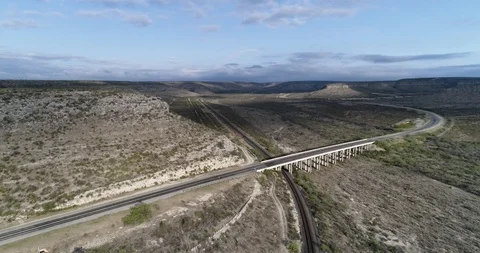 Establishing orbit of bridge over train track, Sanderson, Texas drone aerial 4K Stock Footage 111316561
