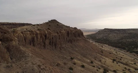 Establishing shot of dramatic rocky faces on top of mountain drone aerial 4K Stock Footage 111316220