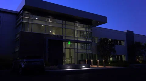Establishing shot of the exterior of a generic modern office building at night. Stock Footage