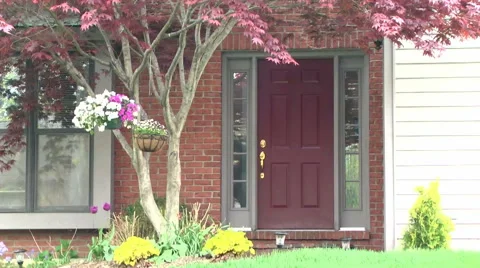 Establishing shot of front door during the daytime in spring Stock Footage 50061772