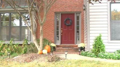 Establishing shot of front door during the daytime in autumn / fall Stock Footage 56343163