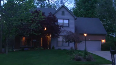 Establishing shot of the front of a middle class house at twilight in spring Stock Footage 50061704