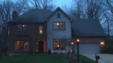 Establishing shot of the front of a middle class house with Christmas lights Stock Footage 58690724