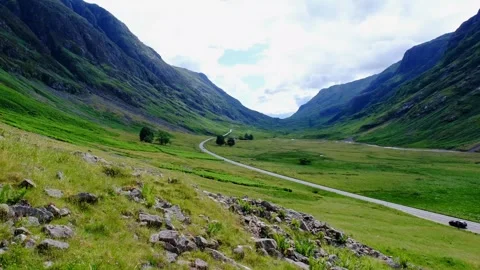 Establishing shot of Glen Coe with road in the Scottish Highlands Stock Footage 246747950