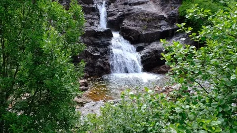 Establishing shot of Glen Coe waterfall in the Scottish Highlands Stock Footage 246747930