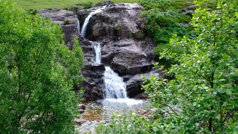 Establishing shot of Glen Coe with waterfall in the Scottish Highlands Stock Footage 246747952