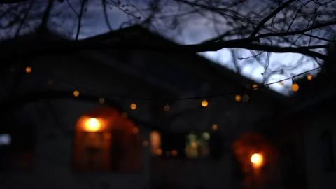 Establishing shot of a house with arches with a string of lights. Stock Footage 148488195