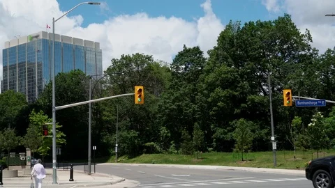Establishing shot of intersection with SUV and Pedestrian. Stock Footage 76934465