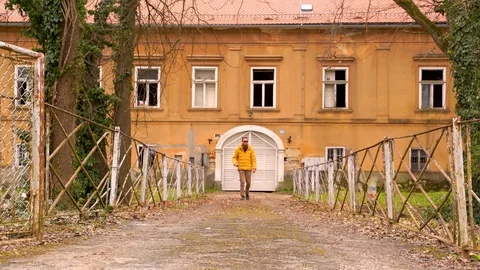 Establishing shot of a man walking through abandoned area, Croatia. Stock Footage 127220050