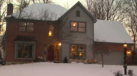 Establishing shot of a middle class house in the snow with Christmas lights Stock Footage 58953210