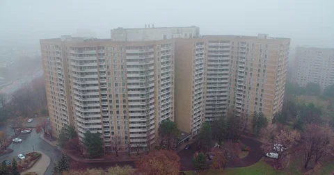 Establishing shot of multi-floor residence on a foggy day. Stock Footage 82496684