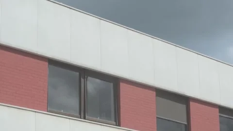 Establishing Shot of Office Style Windows in White and Red Building Stock Footage 325265374