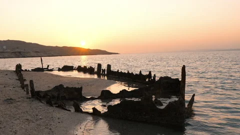 Establishing shot of old ship wreck on the beach Stock Footage 171863897