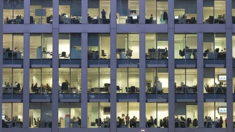 Establishing shot of people working overtime in an office at night Video stock 84476868