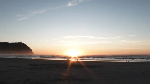 Establishing Shot On Sandy Beach With Sun Low On Horizon Stock Footage 122169206