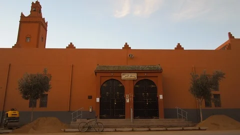 Establishing Shot Small Local Mosque In Arabic Berber Town Car Passing Video stock 100634860