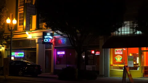 Establishing shot of a small retail storefront business district at night. Stock-Footage 46861989