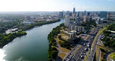 Establishing Shot: Sunrays paint the Austin Skyline &amp; Lady Bird Lake over I-35 Stock Footage 101815942