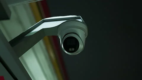 Establishing shot of a white spheric CCTV camera at night Stock Footage 224175384