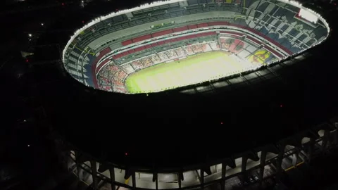 Estadio Azteca aerial drone view at night Mexico City skyline Stock Footage 329344526