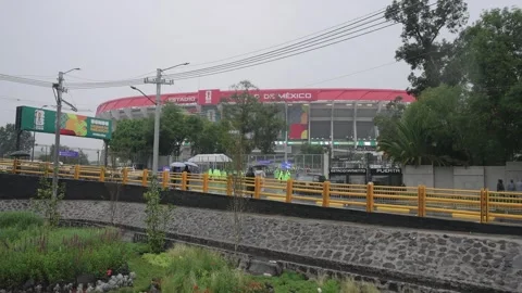 Estadio Azteca seen across a road in the rain Stock Footage 345278467