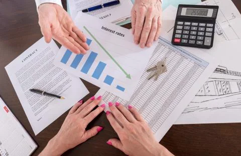 Estate agent showing the decrease of interest rates Stock Photos