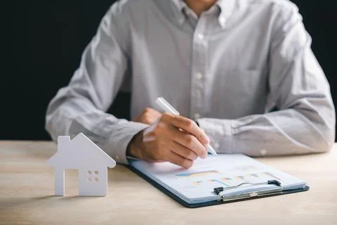 Estate planning involves man writing on financial documents, analyzing new .. Stock Photos