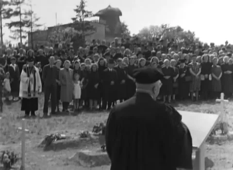 ESTEDT, GERMANY - 1945: Crowd at the graves - Mourners massed among the crosses Stock Footage 344485921