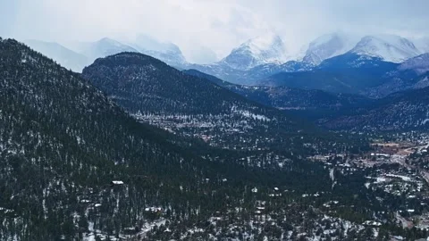 Estes Park mountain valley with dense forest and snow patches Stock Footage 334660304