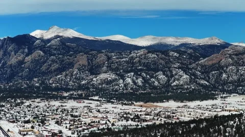 Estes Park town Lumpy Ridge Twin Sisters winter snow morning sunny blue sky Stock Footage 331144112