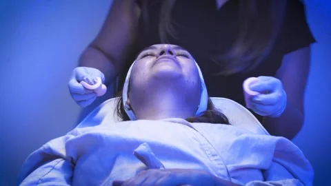 Esthetician applying moisturizing cream during facial treatment Stock-Footage 344610691