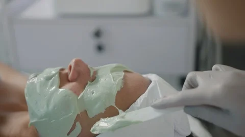 Esthetician does full face mask on client Stock Footage 126339524