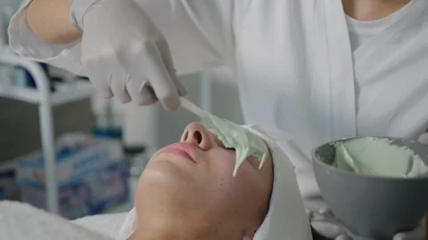 Esthetician does full face mask on client Stock Footage 126339529
