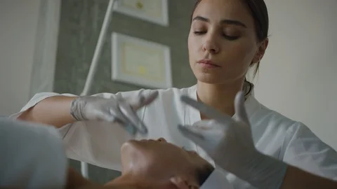 Esthetician massaging face, applying moisturizing cream Stock Footage 126342219