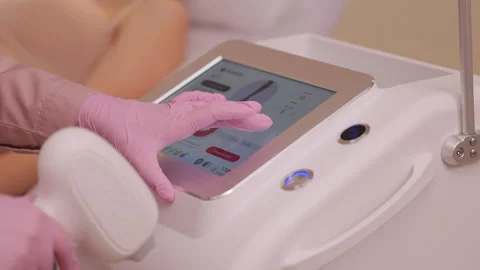 Esthetician preparing equipment for epilation procedure. Hands of beautician Stock Footage 246908062