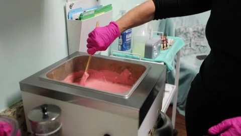 An esthetician waxes a client Stock Footage 141287878
