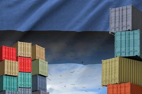 Estonia flag and big stack of shipping cargo containers in docks with sky イラスト素材
