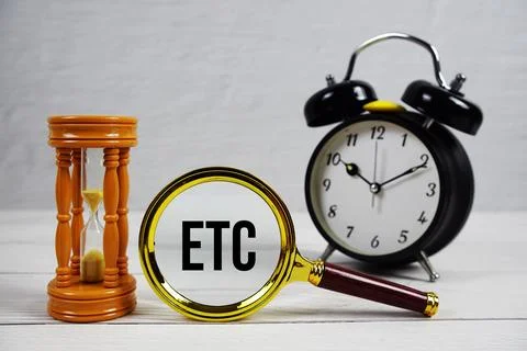 ETC abbreviation of Estimated Time Of Completion text with alarm clock on w.. Stock Photos