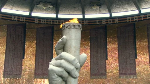 Eternal Flame in Shape of the Hand Holding Burning Torch Made of Stone in Round Video stock 67081287