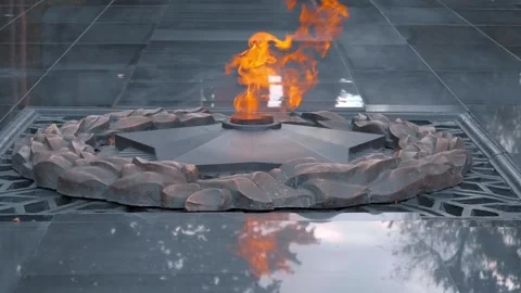 An eternal flame in the shape of a star burns in a park in Almaty Stock Footage 318653572