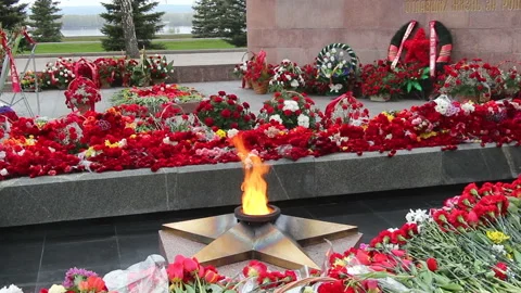 Eternal flame, surrounded by flowers in memory of the Victory in the Great Pa Stock Footage 88728067