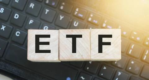 ETF letters on wooden cubes on computer keyboard. Online business concept Stockfoto's